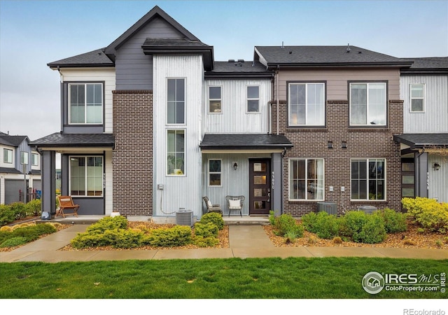 multi unit property featuring central AC unit and brick siding