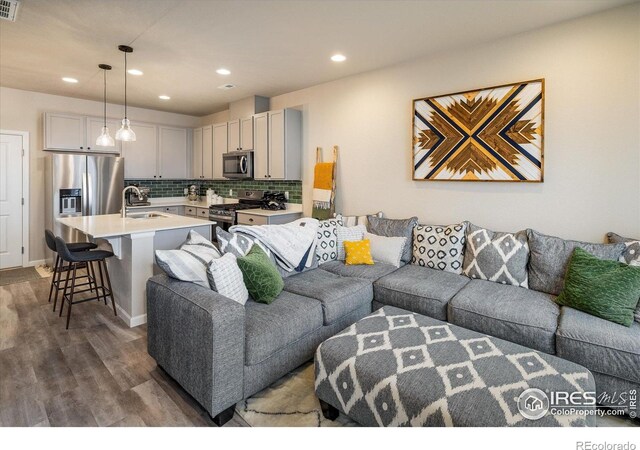 living area featuring dark wood-style flooring and recessed lighting