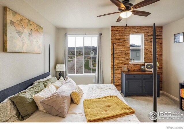 bedroom featuring light colored carpet and baseboards