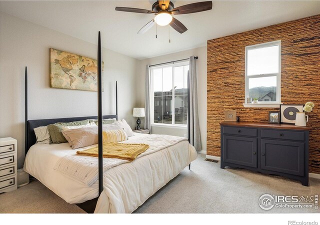 bedroom featuring light colored carpet and ceiling fan