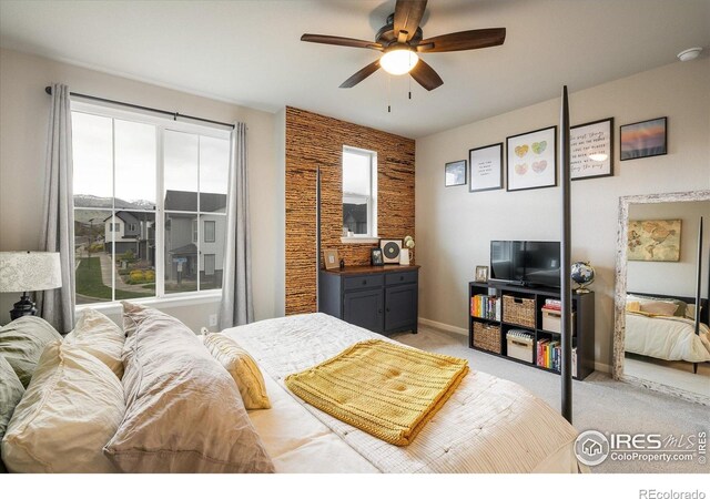 bedroom with light carpet, baseboards, and ceiling fan