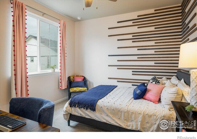 bedroom with carpet flooring, baseboards, and a ceiling fan