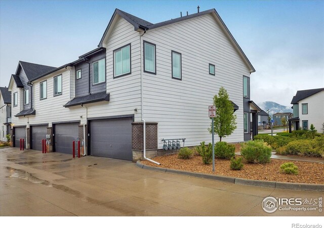 view of property exterior featuring driveway and an attached garage