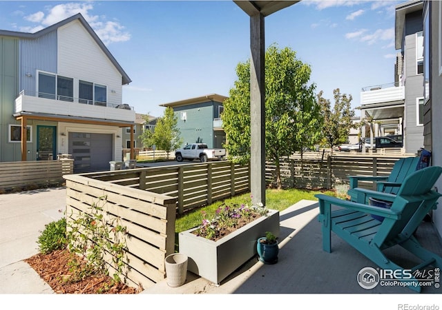 725 Amelia Ln, Lafayette, CO 80026 - view of patio / terrace with concrete driveway, fence, and a garage