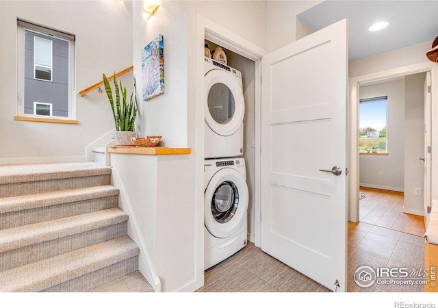 725 Amelia Ln, Lafayette, CO 80026 - washroom with stacked washer / dryer, baseboards, and recessed lighting