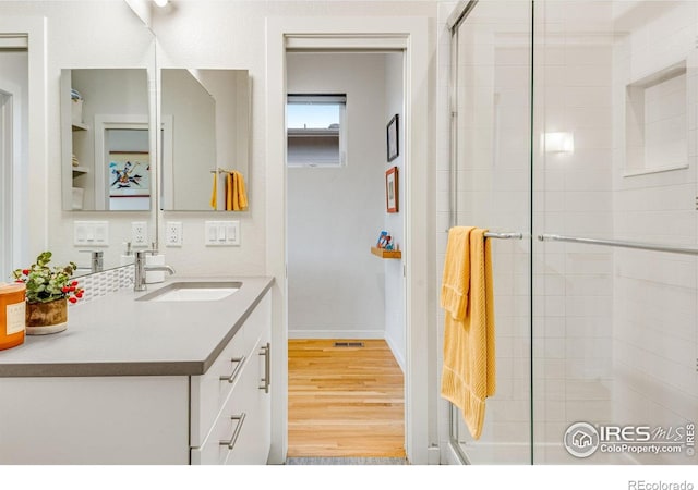 725 Amelia Ln, Lafayette, CO 80026 - full bath with tiled shower, vanity, and wood finished floors
