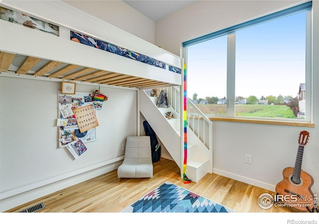 725 Amelia Ln, Lafayette, CO 80026 - bedroom with multiple windows, wood finished floors, and baseboards