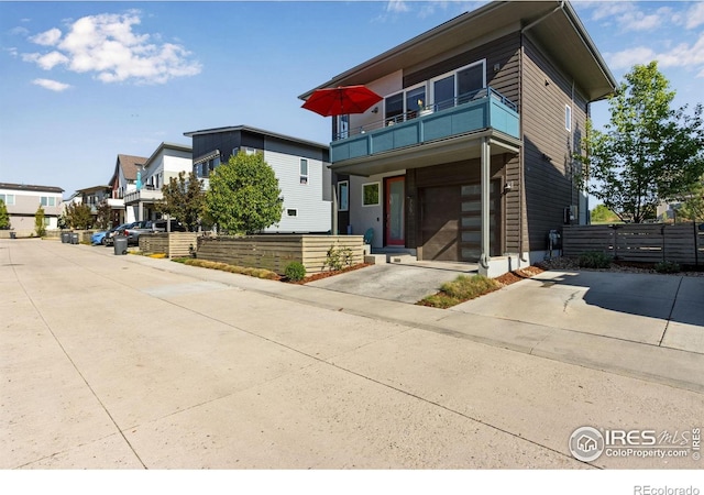 725 Amelia Ln, Lafayette, CO 80026 - modern home with a balcony, fence, and a residential view
