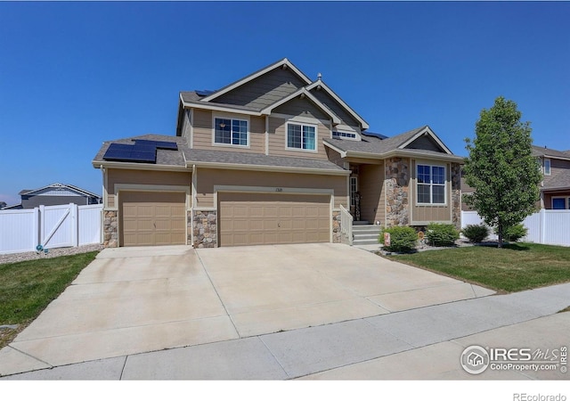 1318 Chamois Dr, Severance, CO 80550 - craftsman-style house featuring stone siding, solar panels, concrete driveway, and an attached garage