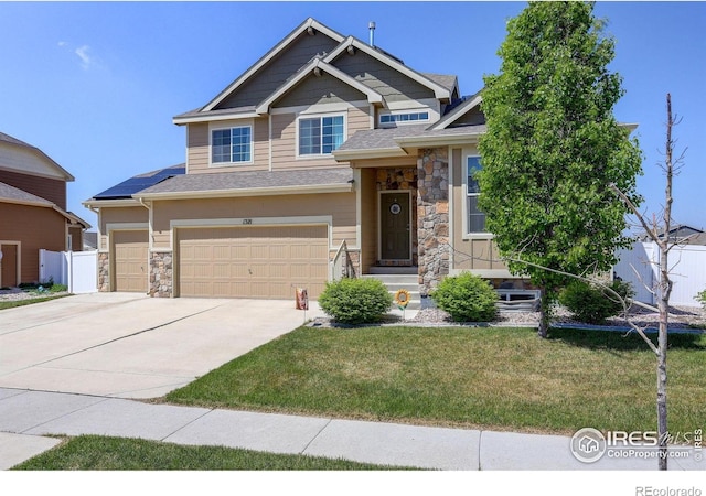 1318 Chamois Dr, Severance, CO 80550 - craftsman-style home featuring stone siding, concrete driveway, a front yard, and a garage
