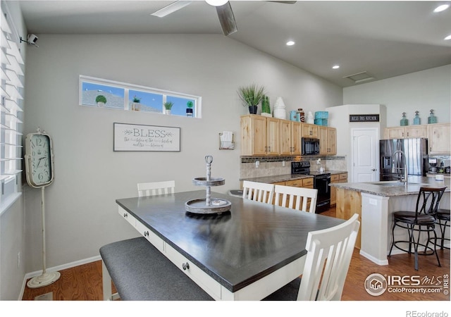 1318 Chamois Dr, Severance, CO 80550 - dining area featuring dark wood-type flooring, high vaulted ceiling, a ceiling fan, and baseboards
