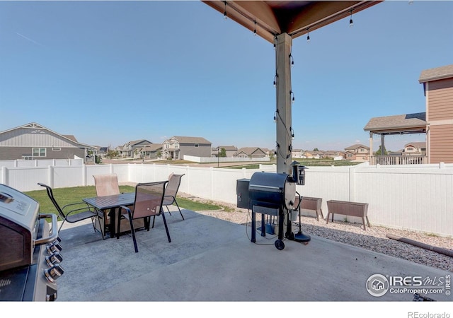 1318 Chamois Dr, Severance, CO 80550 - view of patio / terrace with a residential view, a fenced backyard, a grill, and outdoor dining space