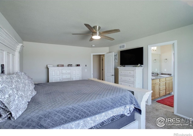 1318 Chamois Dr, Severance, CO 80550 - bedroom with light carpet, ensuite bathroom, ceiling fan, and a sink
