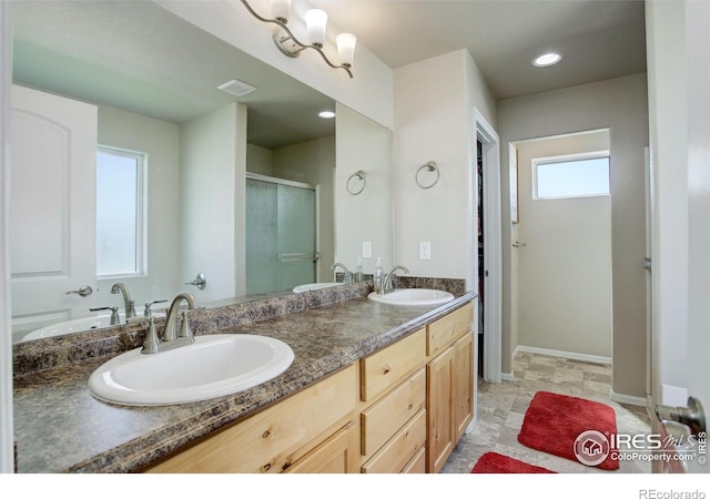 1318 Chamois Dr, Severance, CO 80550 - full bathroom with a stall shower, double vanity, baseboards, and recessed lighting