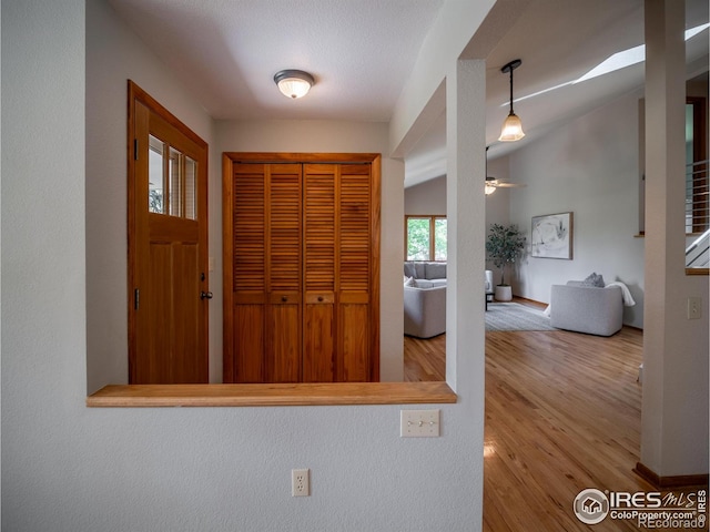 entrance foyer featuring wood finished floors, a ceiling fan, and baseboards