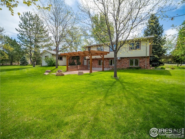 rear view of house with a pergola, a patio, a yard, and brick siding