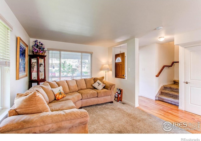 11656 Logan St, Northglenn, CO 80233 - living area with stairs, light carpet, baseboards, and light wood-style floors
