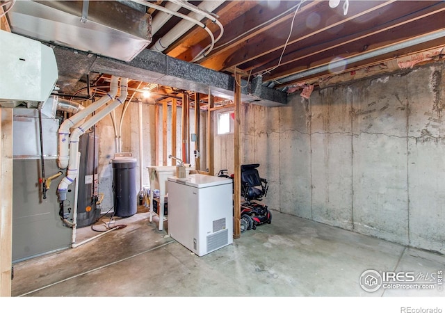 11656 Logan St, Northglenn, CO 80233 - below grade area featuring refrigerator, a water softener, and a sink