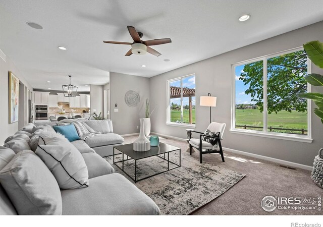 2458 Vale Way, Erie, CO 80516 - living room with baseboards, healthy amount of natural light, a ceiling fan, recessed lighting, and carpet