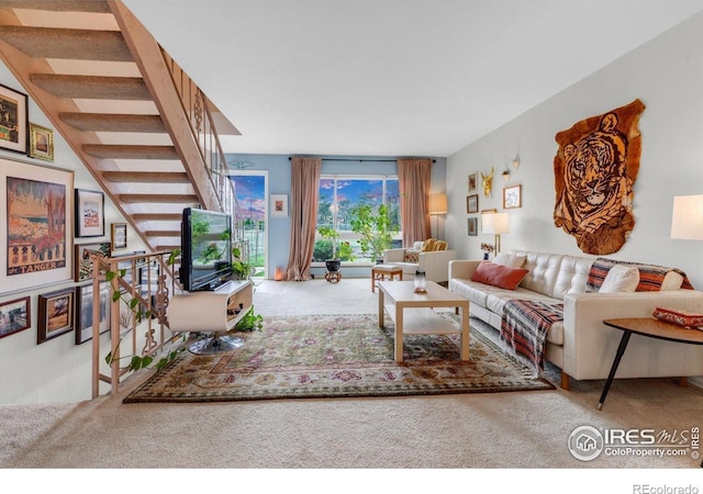 living area featuring carpet floors and stairway