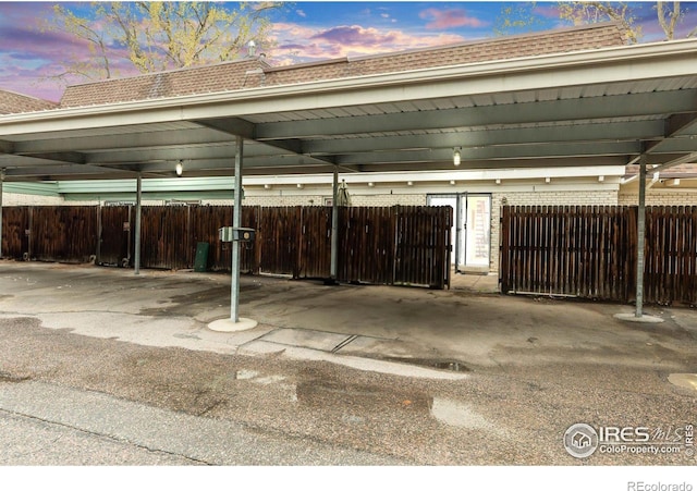 covered parking lot with fence