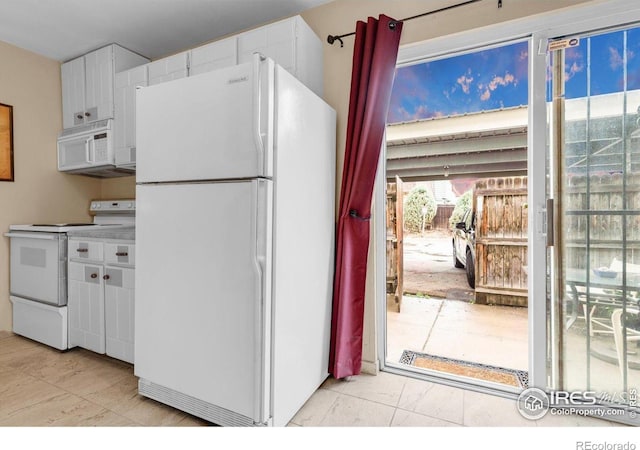 kitchen with white appliances and white cabinets