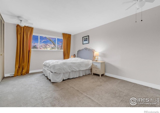 carpeted bedroom with baseboards and a ceiling fan