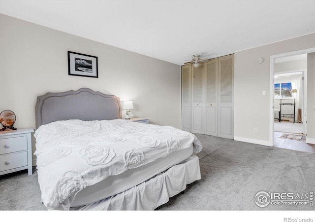 bedroom with a closet, carpet flooring, and baseboards