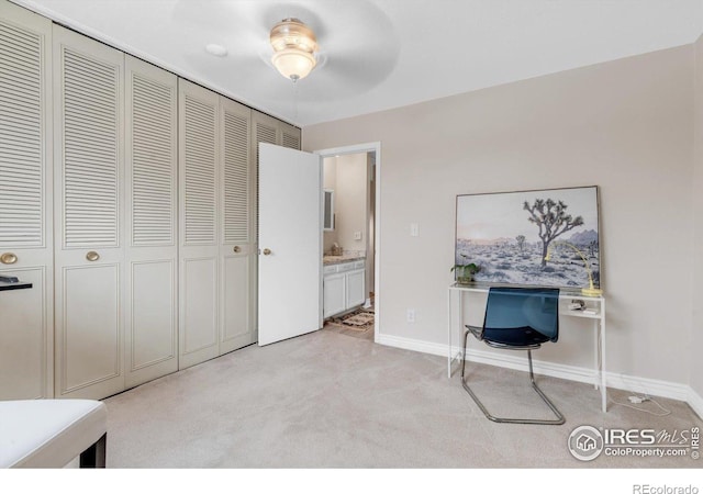 unfurnished bedroom with light colored carpet, a closet, and baseboards