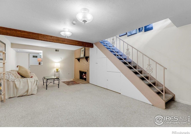living room featuring stairway, carpet floors, beamed ceiling, baseboards, and a brick fireplace