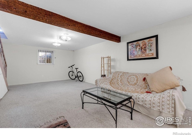 carpeted living area featuring beamed ceiling and baseboards