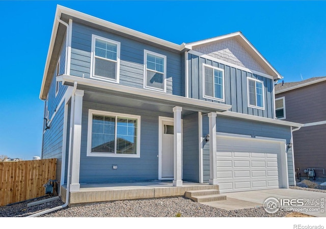 view of front facade featuring covered porch, fence, an attached garage, board and batten siding, and driveway