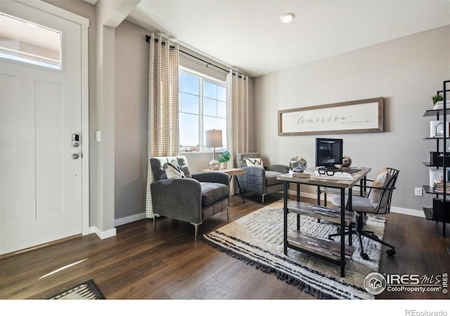 office area with dark wood finished floors and baseboards