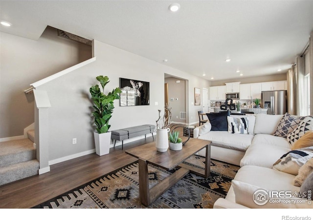 living area with stairway, dark wood-type flooring, baseboards, and recessed lighting