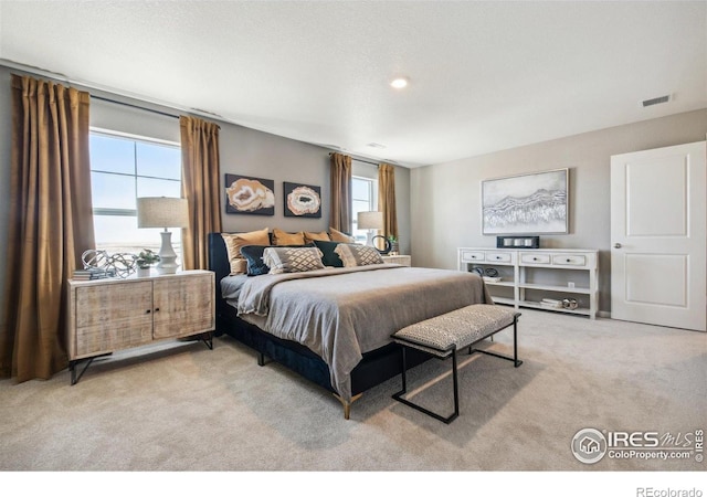 bedroom featuring light carpet