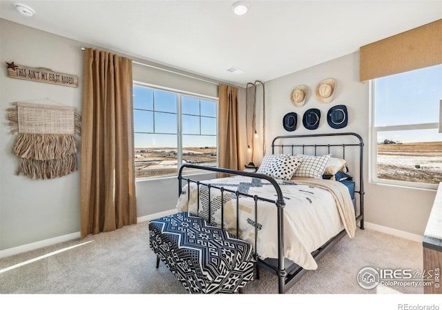 carpeted bedroom featuring baseboards