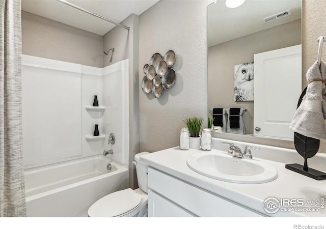 bathroom featuring shower / tub combo with curtain, toilet, vanity, and a textured wall