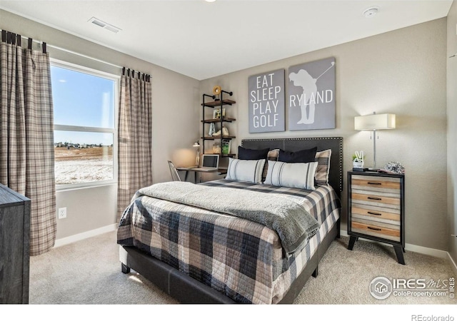 carpeted bedroom with baseboards