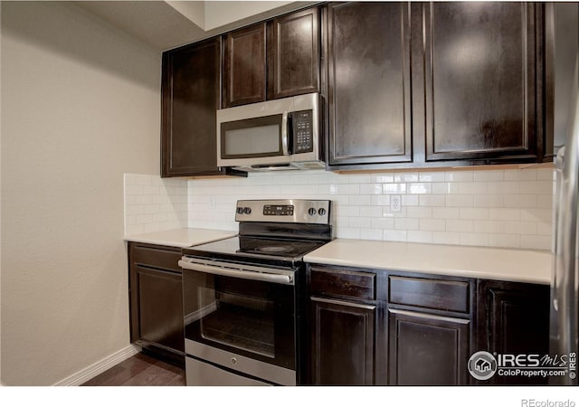 3051 County Fair Ln Unit 2, Fort Collins, CO 80528 - kitchen with appliances with stainless steel finishes, backsplash, light countertops, and baseboards