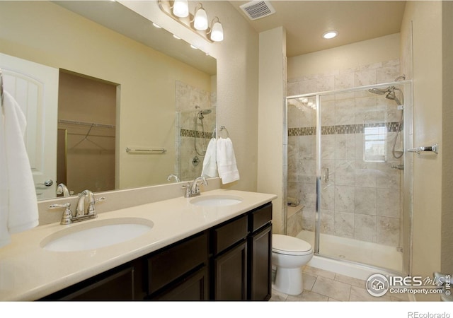 3051 County Fair Ln Unit 2, Fort Collins, CO 80528 - bathroom with a shower stall, tile patterned flooring, double vanity, toilet, and a spacious closet