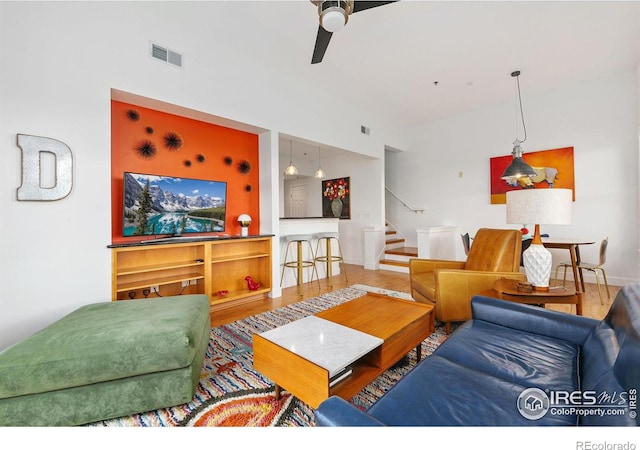 401 Mason Ct Unit 203, Fort Collins, CO 80524 - living room featuring stairway, ceiling fan, and wood finished floors