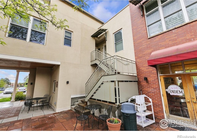 401 Mason Ct Unit 203, Fort Collins, CO 80524 - view of patio with stairs and outdoor dining space