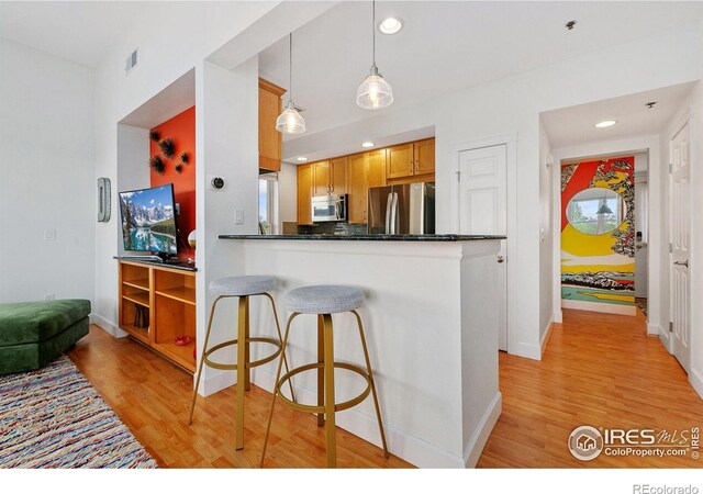 401 Mason Ct Unit 203, Fort Collins, CO 80524 - kitchen featuring appliances with stainless steel finishes, light wood-type flooring, dark countertops, baseboards, and recessed lighting