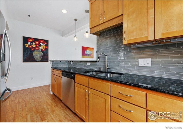 401 Mason Ct Unit 203, Fort Collins, CO 80524 - kitchen featuring appliances with stainless steel finishes, a sink, backsplash, baseboards, and light wood finished floors