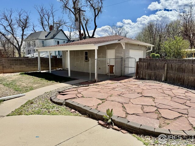 914 15th St, Greeley, CO 80631 - view of side of home featuring a gate and stucco siding