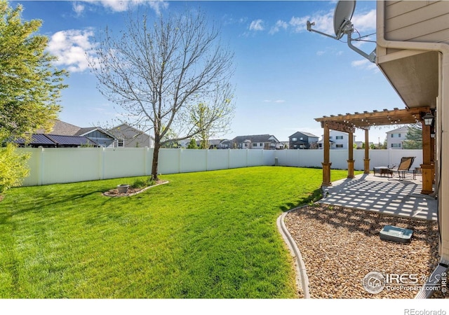 view of yard with a pergola, a patio, and a residential view