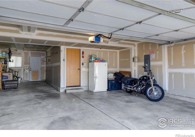 garage with a garage door opener and electric panel