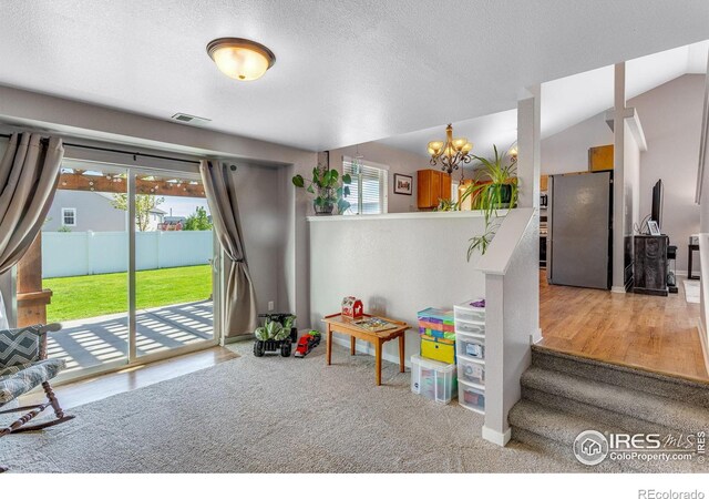 rec room featuring a chandelier, baseboards, a textured ceiling, vaulted ceiling, and carpet flooring