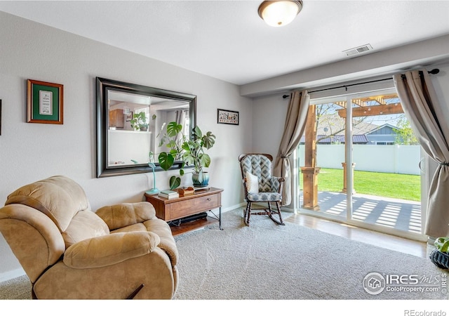 living area featuring baseboards