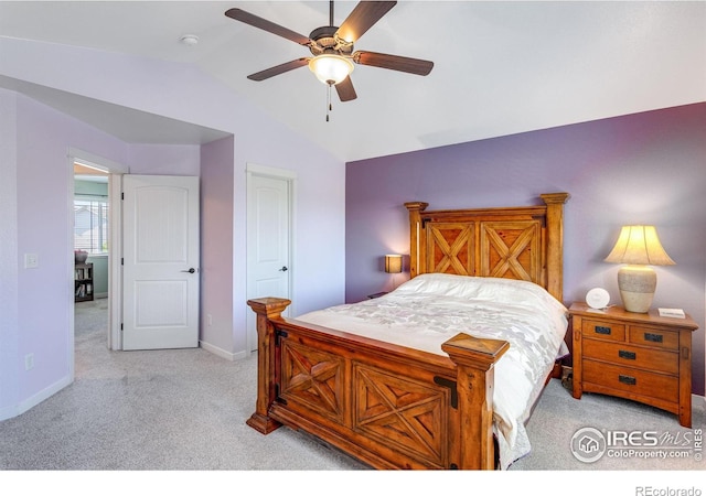 bedroom with light carpet, vaulted ceiling, baseboards, and ceiling fan
